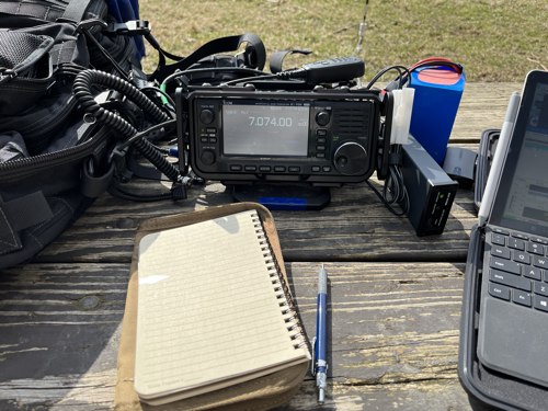 My notebook in front of the IC-705, tuner, and battery.