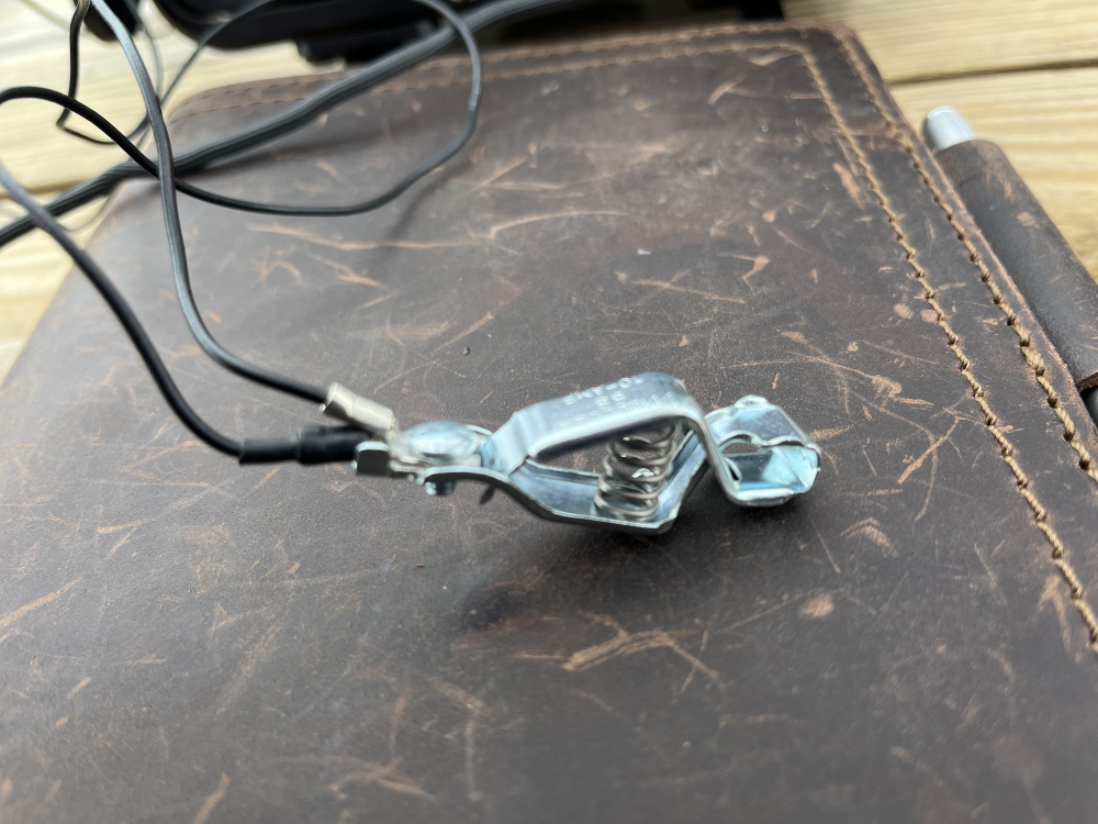 Blurry close up of the counterpoise wires attached to the alligator clip.