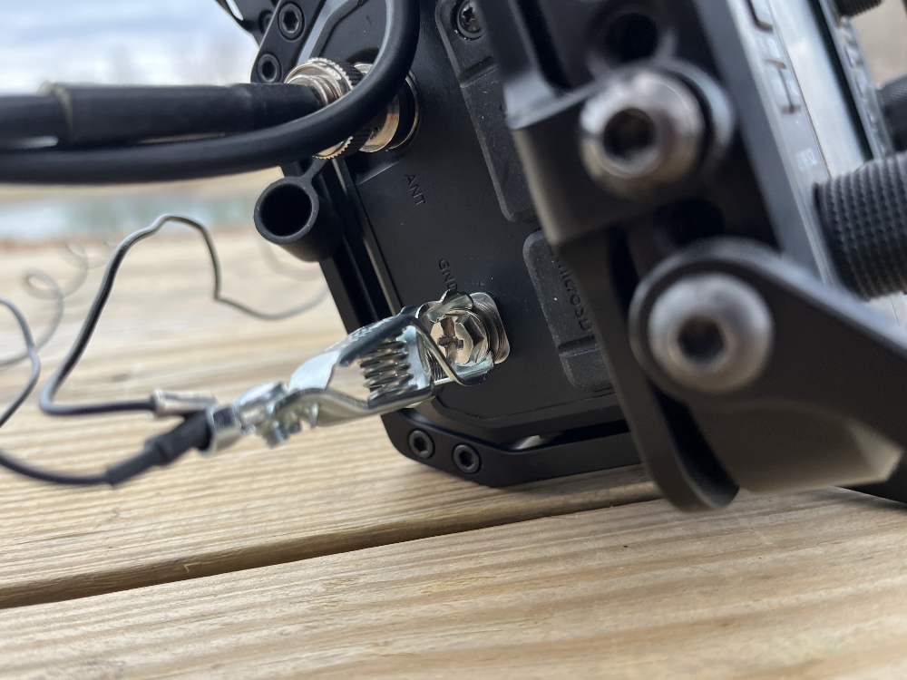 Close up of the alligator clip attached to the ground lug of the IC-705.