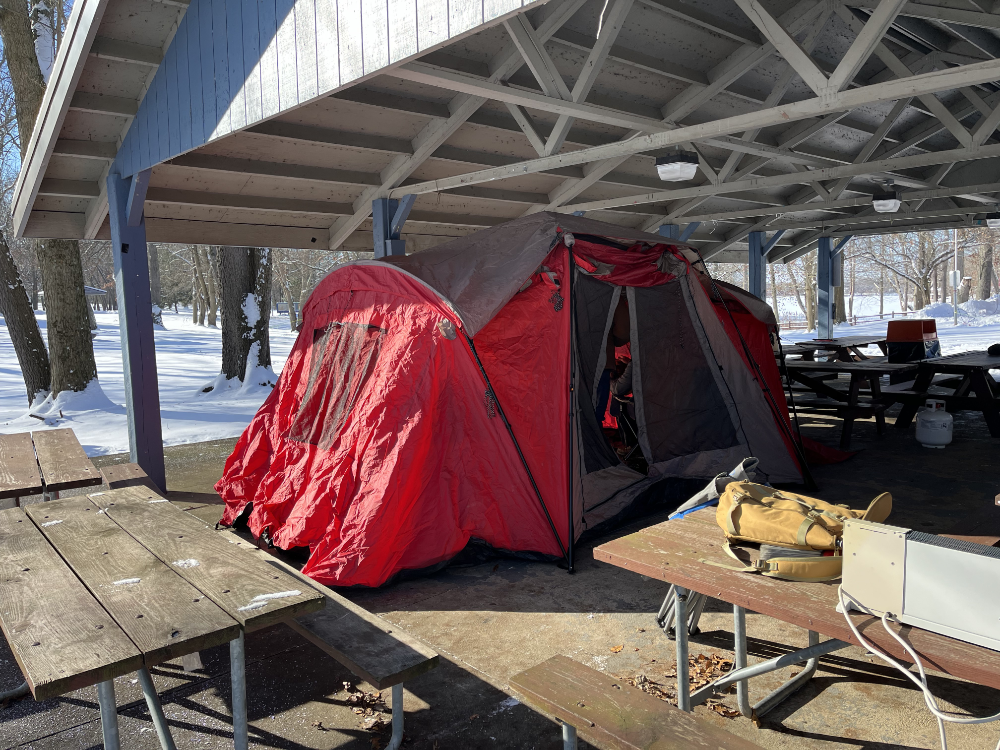 A red tent set up inside of a picnic shelter at Wingfoot Lake State Park.