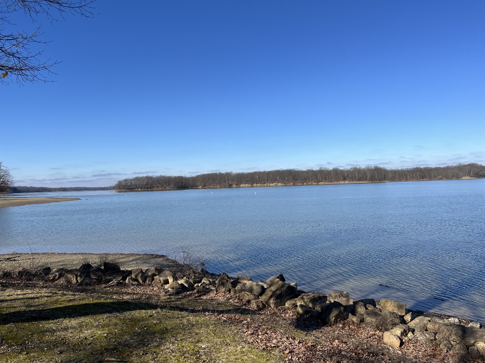 The reservoir in the sun with a blue sky above.