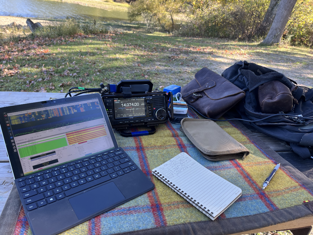 Surface Go 2, IC-705, log book, and gear bags on a tarp.