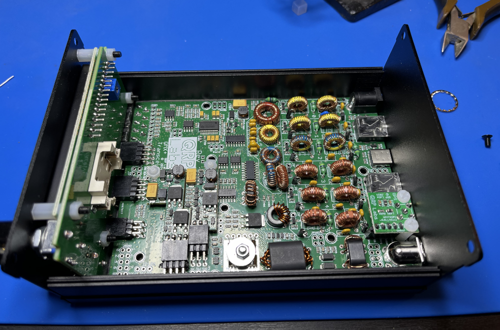 The QMX+ assembled and resting in half of its enclosure.