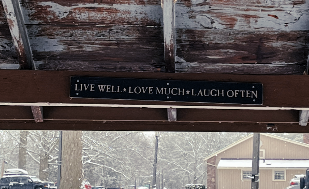 A strange sign hung on the rafters of the shelter. It reads: "LIVE WELL * LOVE MUCH * LAUGH OFTEN" I can only hear it in my head in a Klingon warrior's voice.