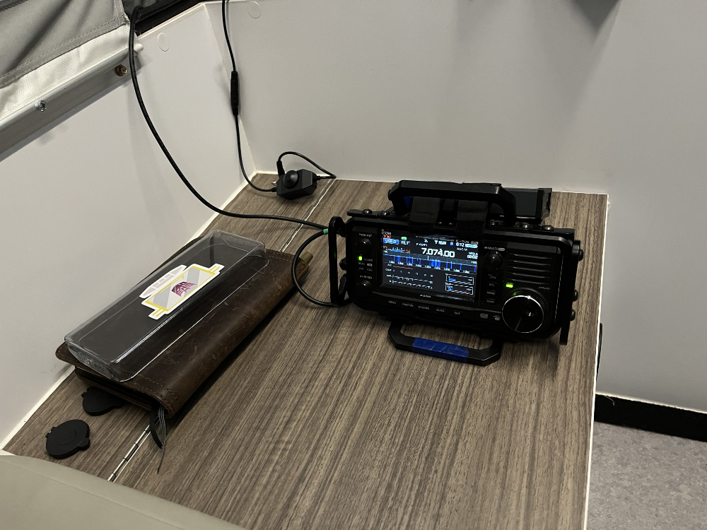IC-705 sitting on a bench inside of the camper.