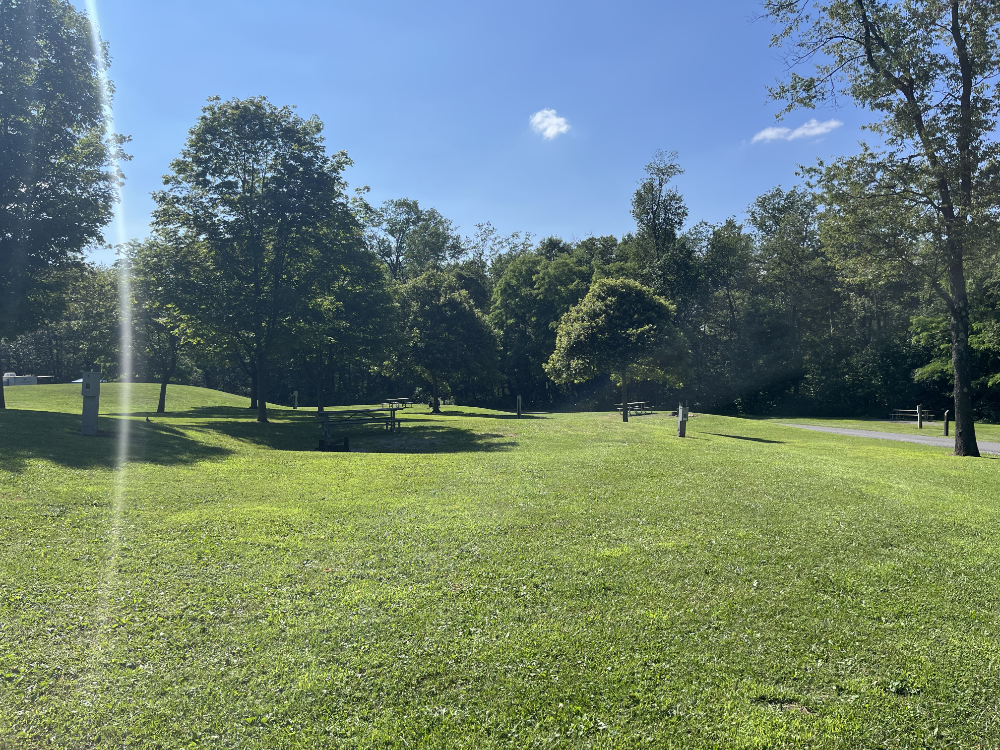 Multiple camp sites in an open field.