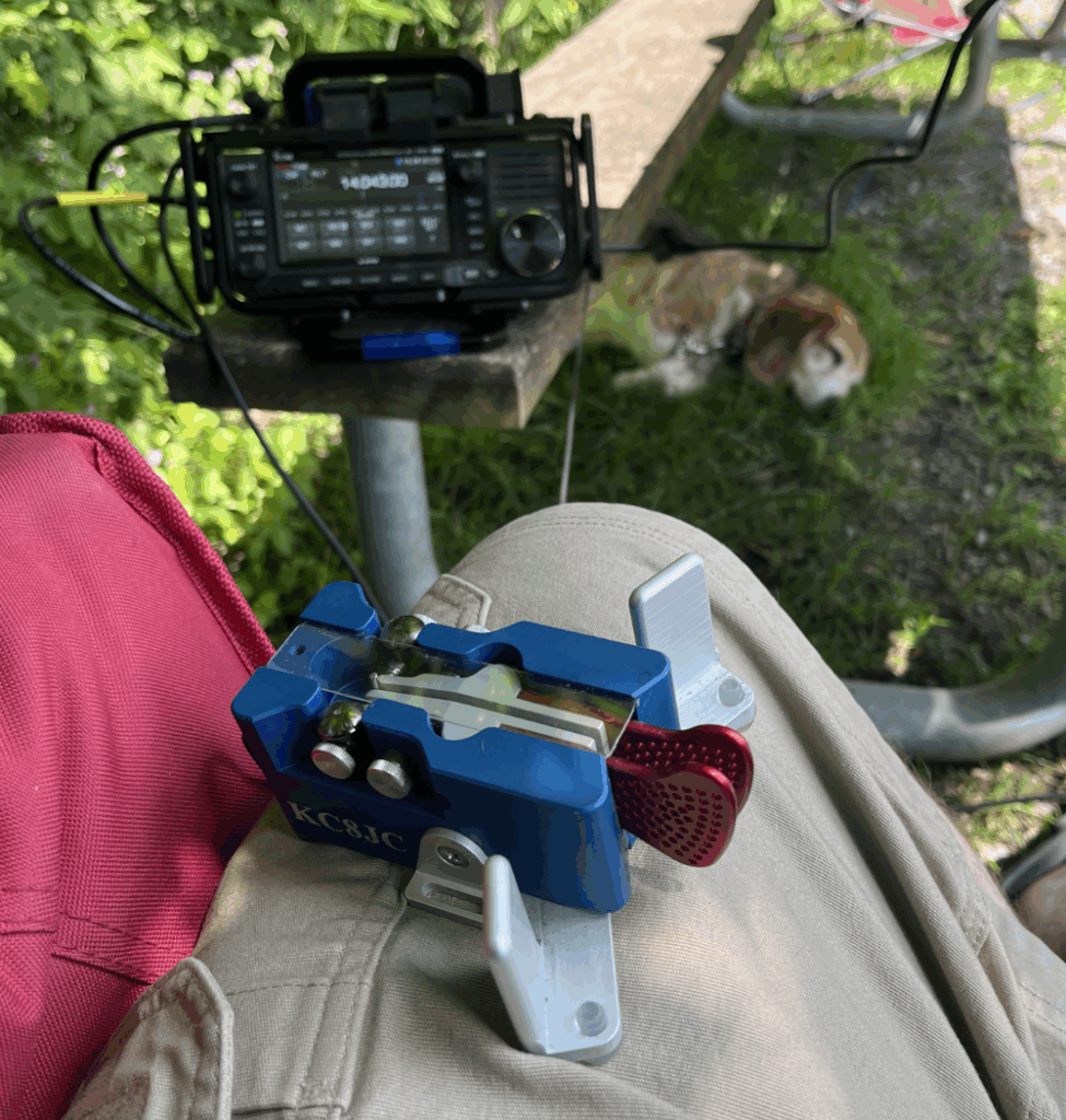 Begali Paddles resting on the author's leg with the IC-705 and Radio Beagle out of focus in the background.