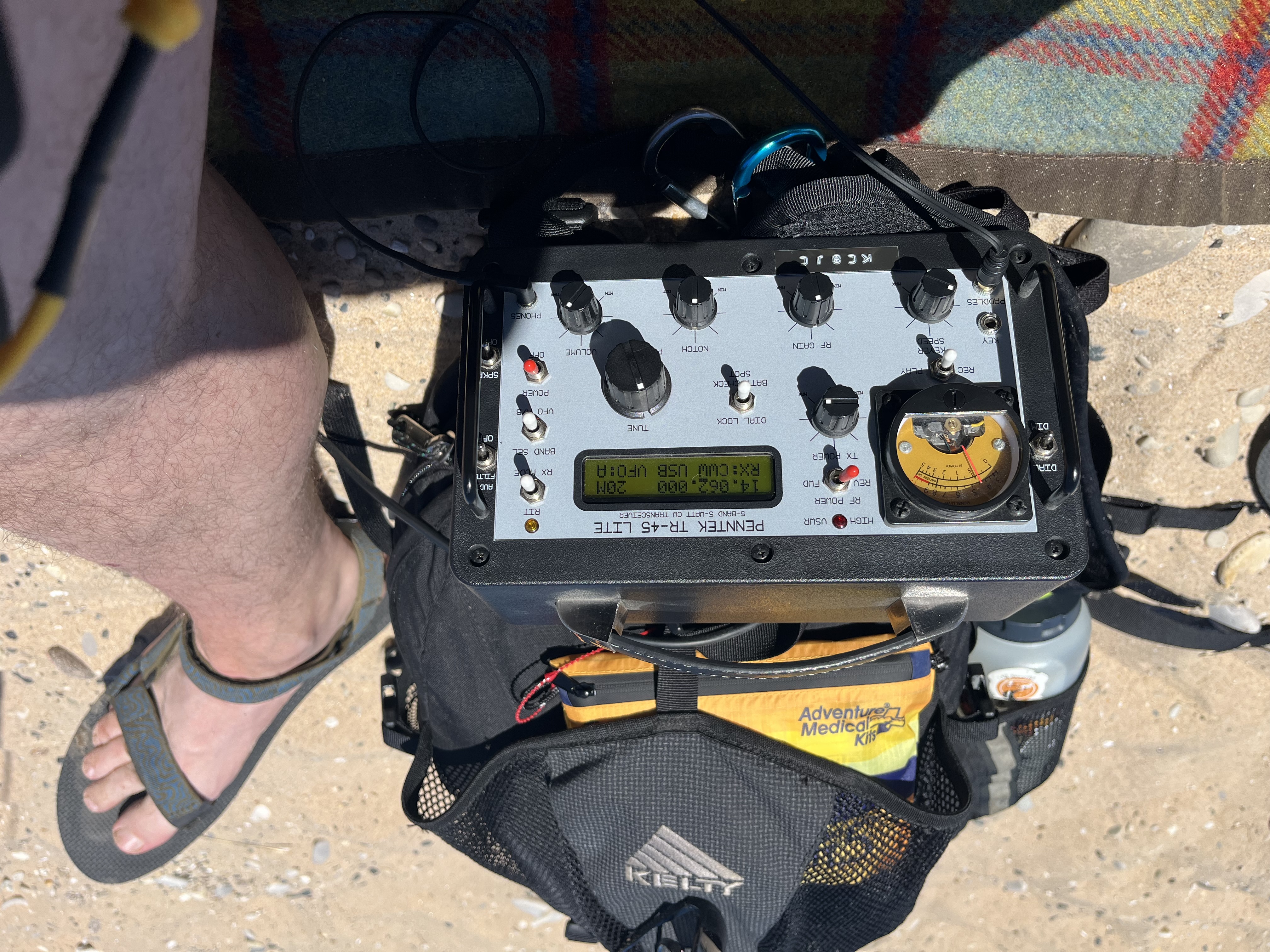 A decent close-up of the TR-45L resting on a backpack on the beach with the author's leg in the shot.