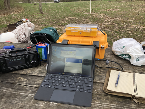 Gear on the table: IC-705, Battery, Surface Go 2, and Notebook.
