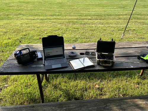 IC-705, Surface Go 2, notebook, and gear on a picnic table.