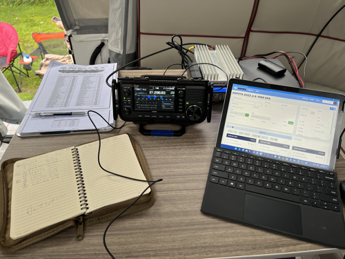 A notebook, the IC-705, and a Microsoft Surface GO 2 on a table.