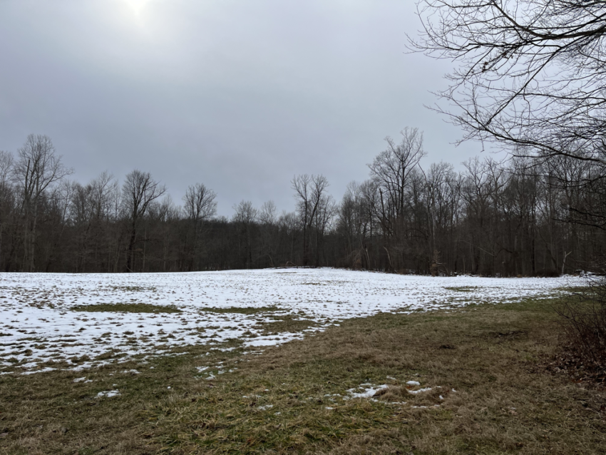 Sun behind clouds at Octagon field at Cuyahoga Valley National Park.