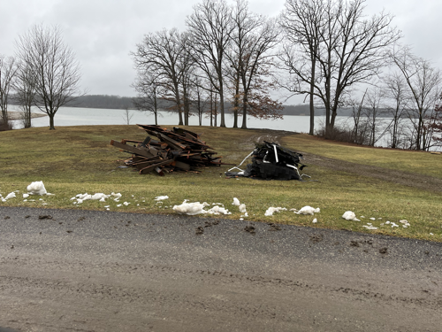 Two piles of wood refuse sitting in front of the spot where a pavilion stood last weekend.