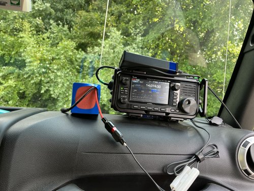 IC-705, tuner, and battery balanced precariously on the Jeep's dashboard.