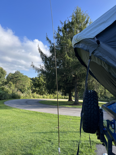 Chameleon antenna set up behind the camper.