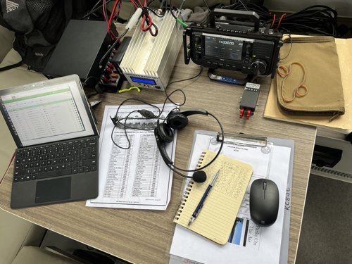 Radio gear set up on the table inside of the camper.