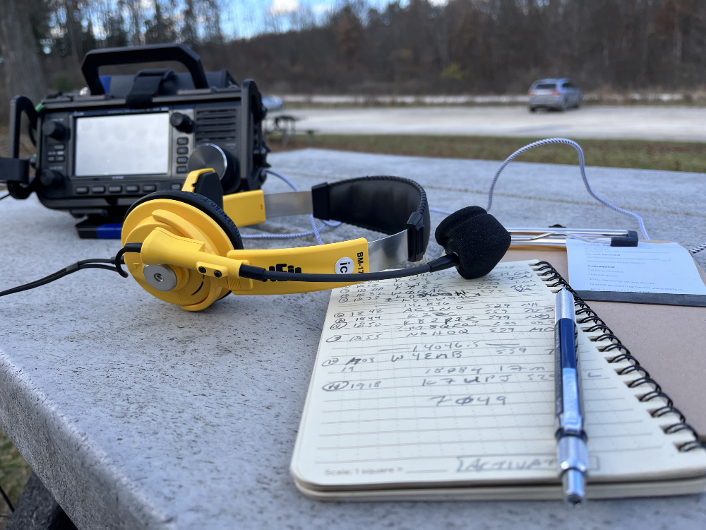 Heil BM-17 IC headset on my logbook in front of the IC-705. They are bright yellow which makes it easier for me to spot them.