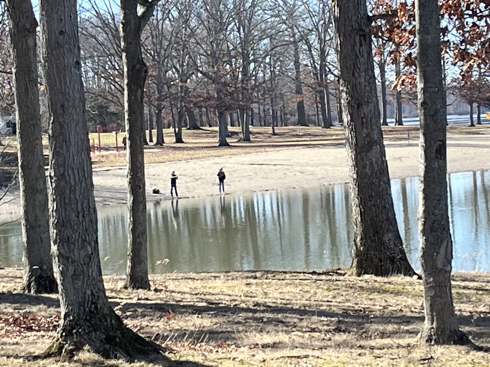 Park patrons out fishing along the reservoir.