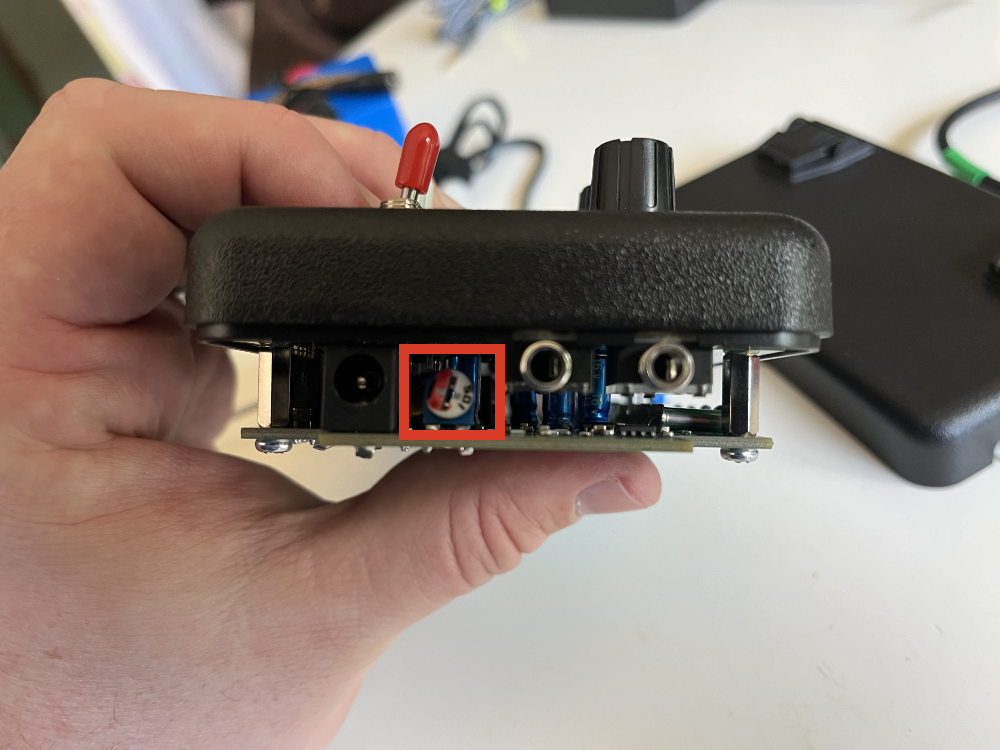 A side view of the TR-35 with its back case removed. The sidetone adjustment knob is highlighted with a red box.