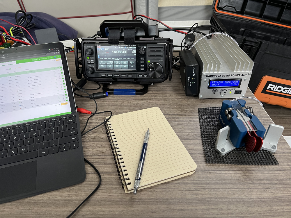 Surface Go 2, IC-705, Log book, Pencil, Hardrock-50, and Begali paddles set up for operation on a grey table.